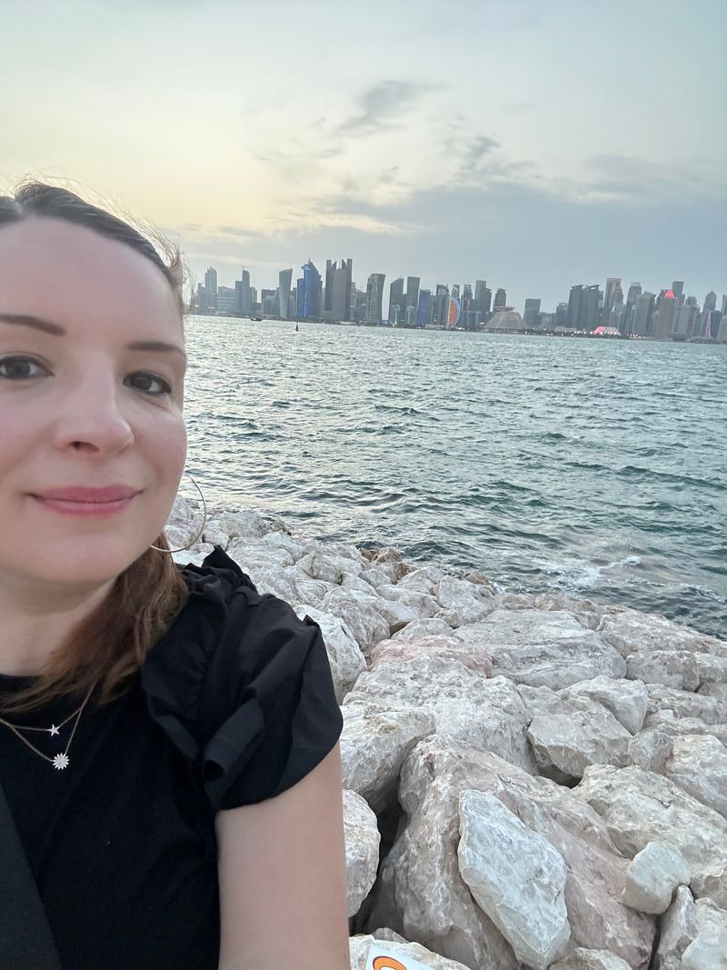 Corina Goetz in front of the Doha West Bay skyline from the Corniche, Qatar